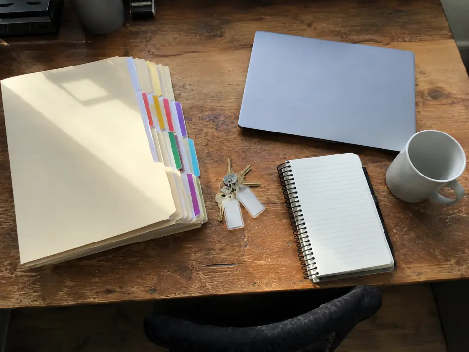 Municipal code printouts and a laptop on a desk